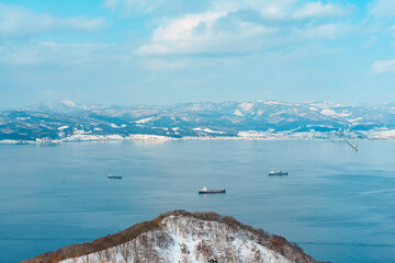 Beautiful landscape and cityscape from Hakodate Mountain with Snow in winter season. landmark and popular for attractions in Hokkaido, Japan.Travel and Vacation concept - obrazy, fototapety, plakaty