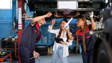 Young Asian female auto business entrepreneur discusses with mechanical worker team, checklist...