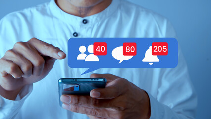 Man's hand touching smart phone screen with social media notification bubble
