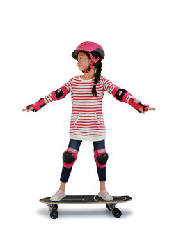 Asian little girl kid skateboarder with wearing safety and protective equipment stand on skateboard isolated on white background. Image with Clipping path.