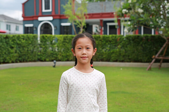 Portrait of Asian girl child in the garden at public park outdoor.