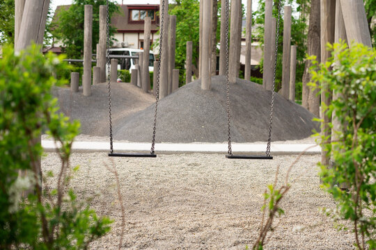 Two children's swings in the summer park.