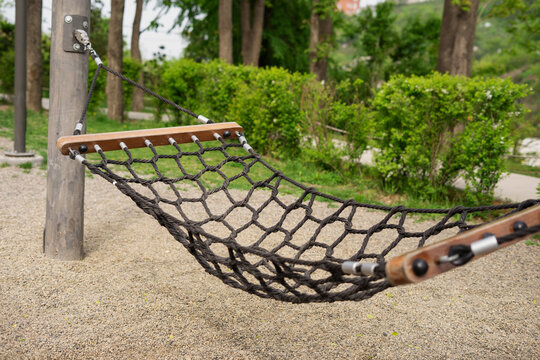 Modern play hammock in a summer park.