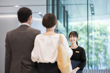Image of a woman in the hospitality industry who guides people at reception, concierge, hotel front desk, etc.