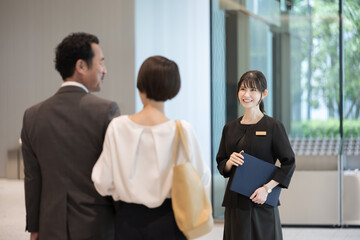 Image of a woman in the hospitality industry who guides people at reception, concierge, hotel front...