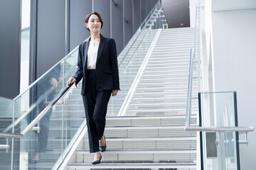 Beautiful career woman-like woman walking in office building Wide angle