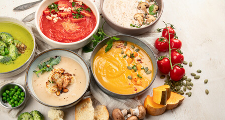 Composition with various soups, ingredients and space for text on white background. Healthy food.