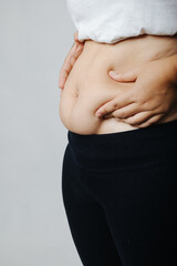 Women with abdominal fat, obesity problems, fat accumulation, diet, exercise, weight loss, postpartum women's abdomen fat accumulation after giving birth