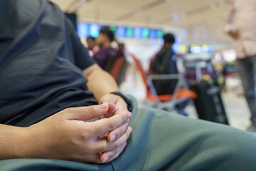 Man waiting for flight in airport departure area at airport waiting the flight