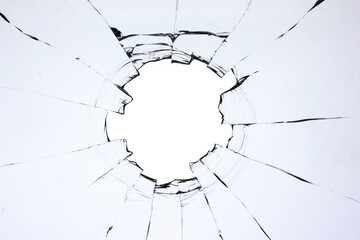 Hole in the glass, broken window with cracks texture. Effect of broken transparent glass