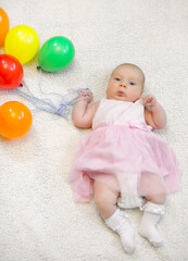 little girl holding a bunch of balloons and flight shows