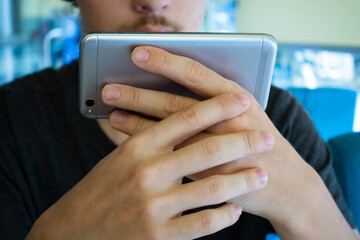 smartphone in hand with modern design on cafe background