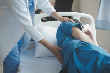Obraz premium Doctor or Physiotherapist working examining treating injured arm of athlete male patient, stretching and exercise, Doing the Rehabilitation therapy pain in clinic.