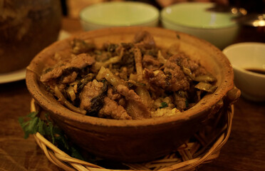 Mixed beef and pickled cabbage rice served in clay pot in a Vietnamese restaurant