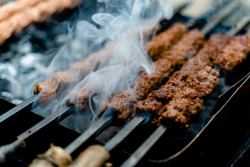 Sheekh Kabab being cooked over a grill.