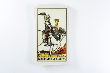 Tarot cards, Rider Waite tarot cards, the knight of cups vintage card in the foreground.