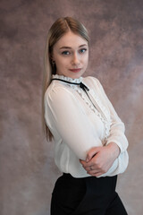 Portrait of young caucasian business woman in white blouse