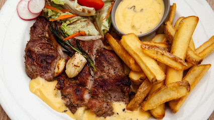 Pork steak with french fries and salad