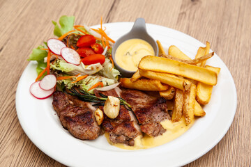 Pork steak with french fries and salad