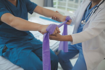 Professional orthopedist examining little patient's leg in clinic