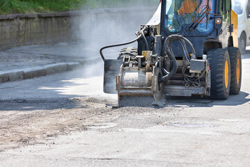 Industrial milling of the old asphalt pavement for the subsequent renovation of the roadway. - 607259069