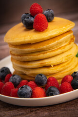 Recipe for maple syrup pancakes with raspberry and blueberry filling, High quality photo