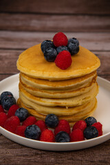 Recipe for maple syrup pancakes with raspberry and blueberry filling, High quality photo