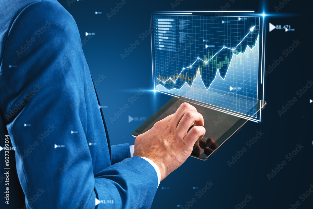Poster close up of businessman hands using tablet with glowing business graph hologram on blurry blue backg