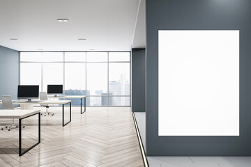 Fototapeta premium Front view on blank white poster on dark grey wall with space for your logo advertising in modern open space office with table and chairs on wooden floor. 3D rendering, mockup
