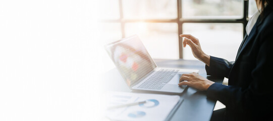 Consultant, advisor, Asian business woman working on the tablet computer work financial and marketing business plan to increase company profits, ready to use computer and marketing planning documents