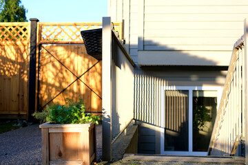 Front door entrance to basement apartment of home or house in urban city with welcome mat at top of...