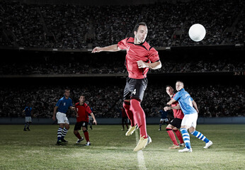 Soccer player jumping on field