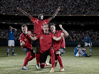 Soccer players cheering on field