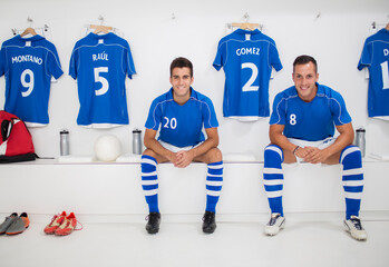 Soccer players smiling in locker room