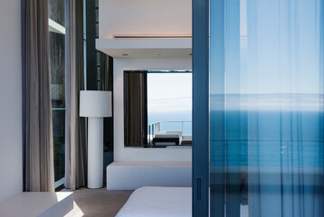 Fototapeta na wymiar Glass door and windows of modern house overlooking ocean