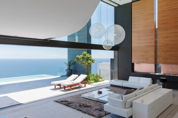 Living room and patio of modern house overlooking ocean