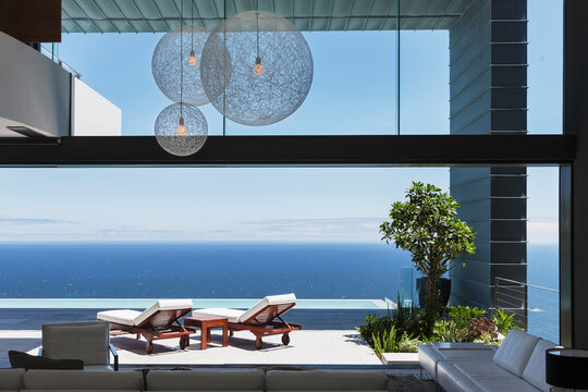 Lounge chairs on balcony overlooking ocean