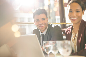 Business people smiling in restaurant