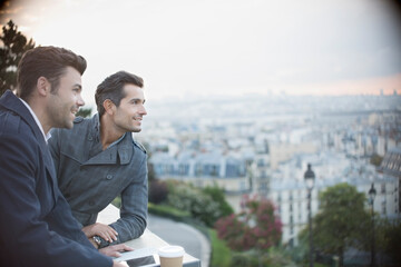 Businessmen overlooking cityscape, Paris, France