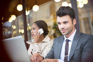 Business people working at sidewalk cafe