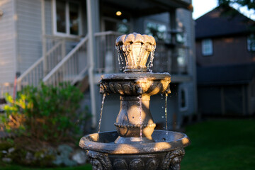 Defocused drops of water from a fountain at the setting sun. Slow motion. Drops of water in the air...