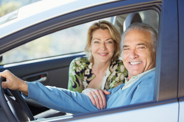 Portrait of happy senior couple in car