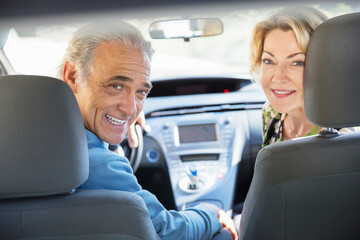 Portrait of happy senior couple inside car