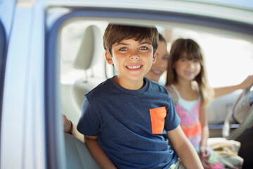 Portrait of smiling boy inside car