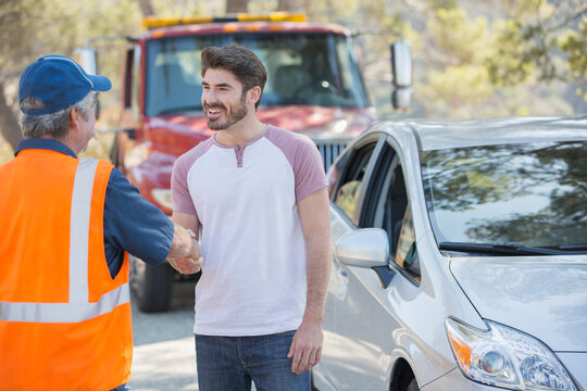 Man shaking hands with roadside mechanic
