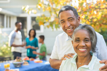 Portrait of smiling senior couple at barbecue