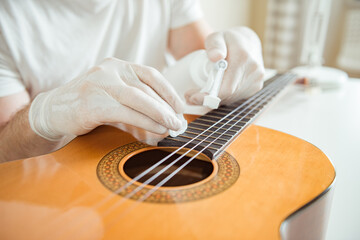 Cleaning guitar fretboard with wet wipes made for guitar