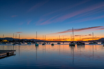 Fototapeta na wymiar Beautiful sunrise with high cloud and boats on the water