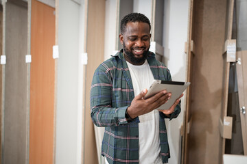 Portrait African American carpenter use paper work with wood sheet at wood factory