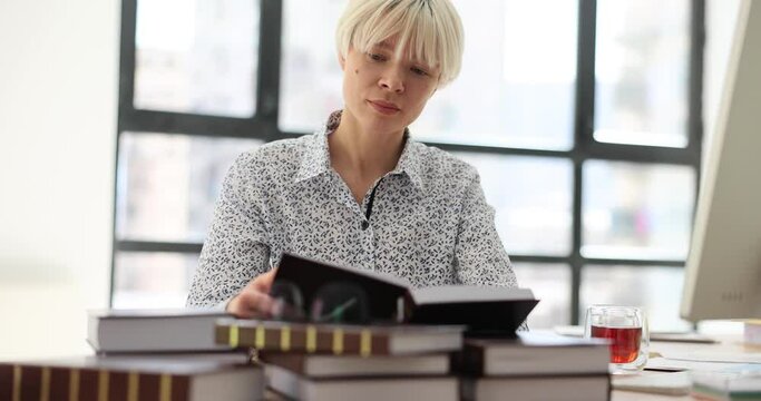 Business woman leafing through diary or book in office. Study of international law